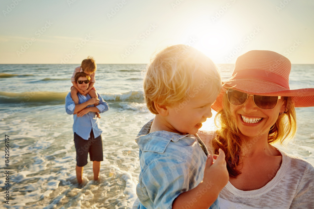 Happy mother, family and beach with hug for bonding, outdoor holiday or weekend in sunset or nature. Mom, child and little boy with smile for embrace, love or care in sunshine by ocean coast or sea Happy mother, family and beach with hug for bonding, outdoor holiday or weekend in sunset or nature. Mom, child and little boy with smile for embrace, love or care in sunshine by ocean coast or sea