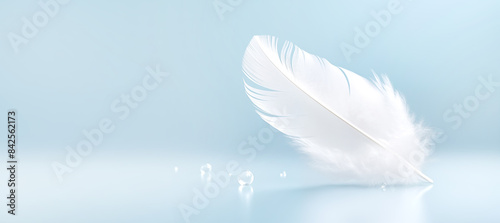 white light feather drop of water blue background