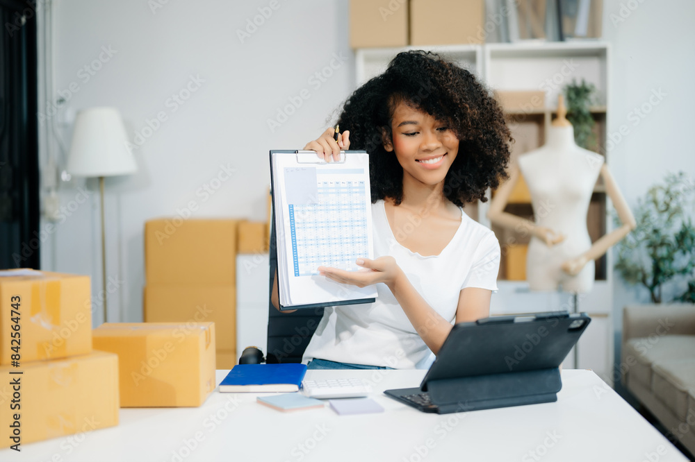 Asian young woman SME working using smartphone or tablet taking receive and checking online purchase shopping order Asian young woman SME working using smartphone or tablet taking receive and checking online purchase shopping order