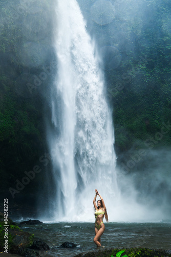 oman Performing Yoga Pose in Front of a Tropical Waterfall