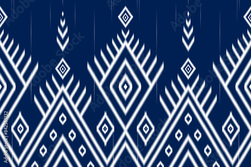 Ethnic ikat fabric pattern traditional folk style, geometric ethnic seamless pattern on blue background, vector illustration. Design for clothing, carpet, curtain, wallpaper, wrapping, Batik