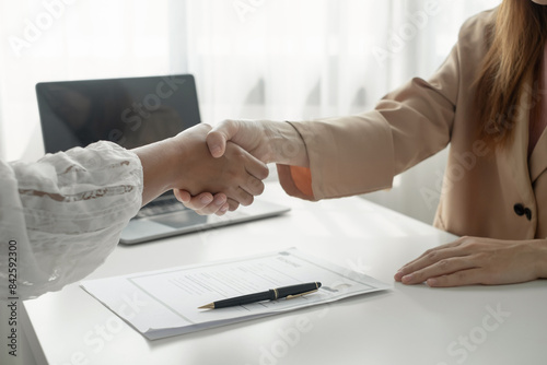 Friendly businessmen and executives shake hands after successful agreement with employment contracts, recruitment, and employment concepts