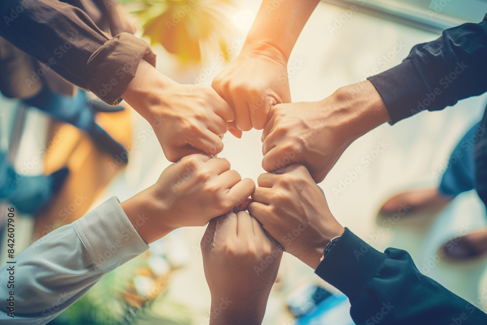 A group of people are holding hands in a circle. Concept of unity and togetherness A group of people are holding hands in a circle. Concept of unity and togetherness