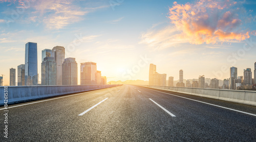 Asphalt highway road and city skyline with modern buildings at sunrise in Chongqing. Panoramic view.