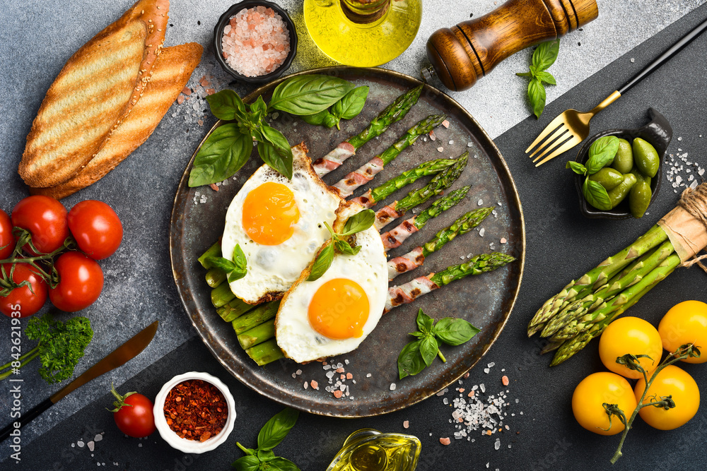 Delicious Breakfast: A plate with fried asparagus, bacon and fried eggs. Delicious Breakfast: A plate with fried asparagus, bacon and fried eggs.