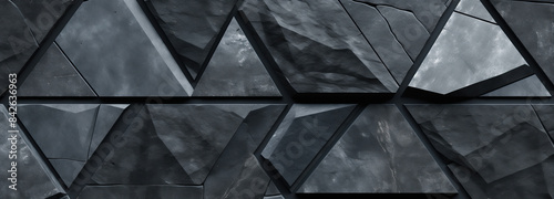 A close-up shot of a textured  abstract geometric pattern composed of black triangles. The image features a rough  natural surface and a repeating pattern of triangles