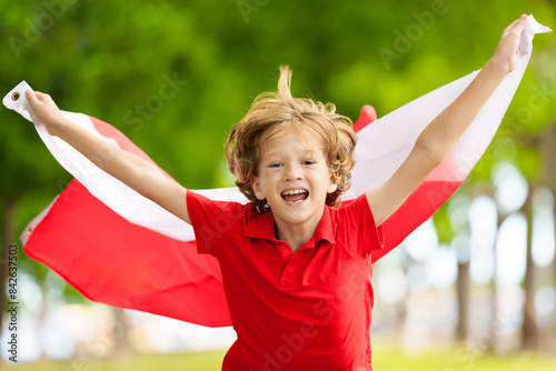 Child running with Poland flag. Little Polish fan