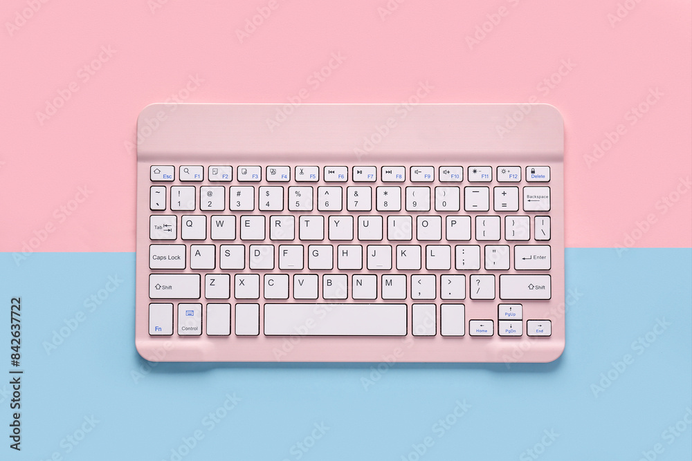 Pink computer keyboard on pink blue background. Top view Pink computer keyboard on pink blue background. Top view