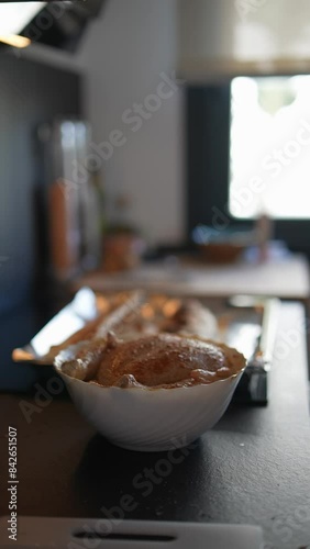 Freshly baked bread rolls in bowl and tray evoke warmth and comfort of homemade culinary delights photo
