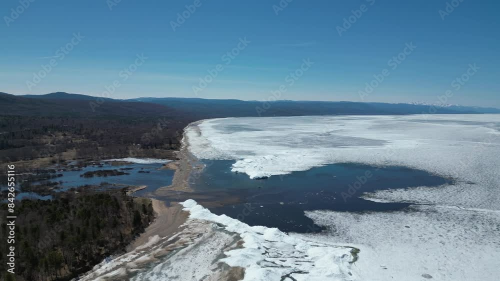 custom made wallpaper toronto digitalAn airy beautiful shot on a sunny frosty day. The camera takes a bird's-eye view. The river flows into the sea or into a large frozen lake, breaking up snow and ice for its course. High quality 4k