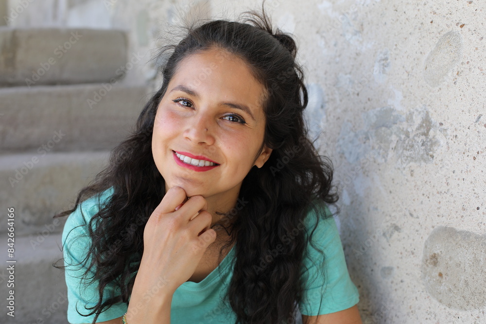 Natural Hispanic woman headshot in green top Natural Hispanic woman headshot in green top