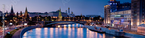 View of illuminated city skyline with historic buildings and reflection on river, Khamovniki, Moscow, Russia. photo
