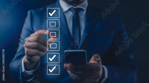 Businessman holding a mobile phone checking a list with mark icons on a virtual screen.depicting a business concept for an online questionnaire  photo