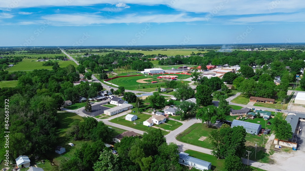 Obraz premium Aerial view high school baseball field with farm houses, large farmland in Fairland agriculture town, U.S. Highway 60, State Highway 125, Ottawa County, Oklahoma, business and residences building