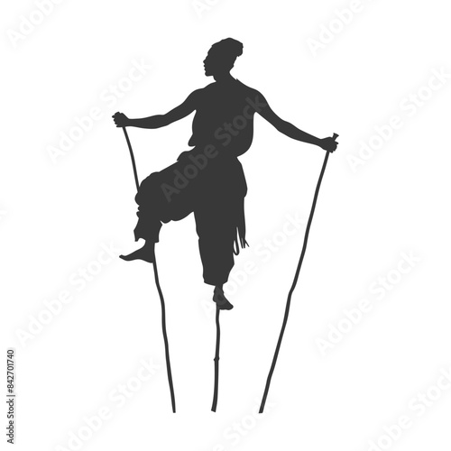 Silhouette of a Stilt Walker: Traditional Acrobat Balancing Act