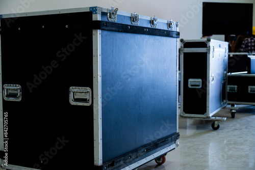 Flightcase of concert music and video equipment stacked behind the stage