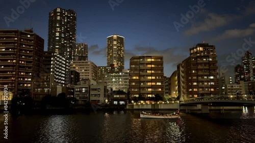 Wallpaper Mural City skyline and river at dusk with a boat passing by illuminated buildings Torontodigital.ca