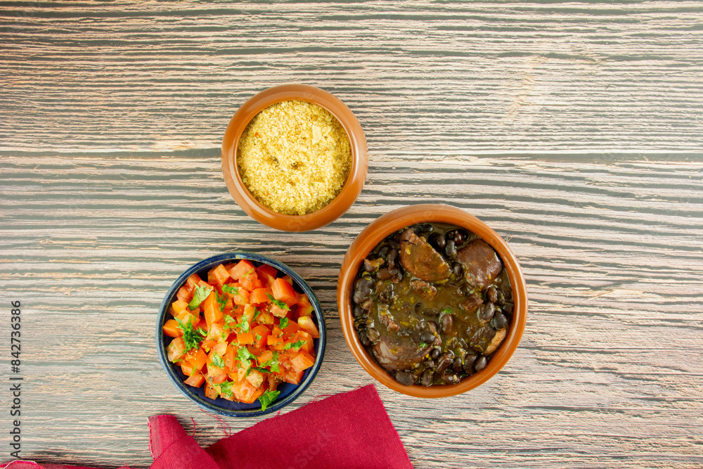 Brazilian Feijoada Food black bean stew with bacon, pork sausage and dried meat Brazilian Feijoada Food black bean stew with bacon, pork sausage and dried meat