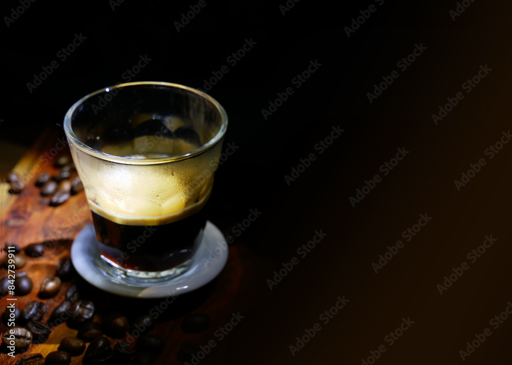 Espresso coffee and beans. Black background. Selective focus. Espresso coffee and beans. Black background. Selective focus.