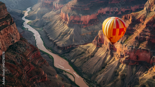 Striped hot air balloon above the Grand Canyon at sunset, rays of sun in the background. (AI generative) photo