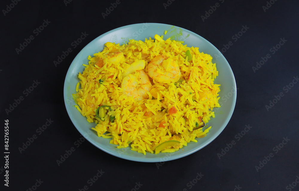 Arab Fried Rice or Prawn Biryani or Kao Pad in white plate on gray concrete backdrop. Tom Yum Fried Rice is Thailand cuisine dish with jasmine rice black background Arab Fried Rice or Prawn Biryani or Kao Pad in white plate on gray concrete backdrop. Tom Yum Fried Rice is Thailand cuisine dish with jasmine rice black background