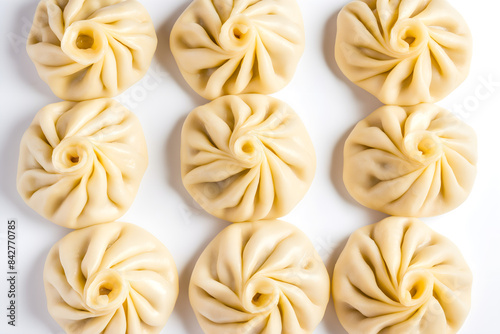 perfectly formed khinkali  which are traditional Georgian dumplings  arranged neatly on white background