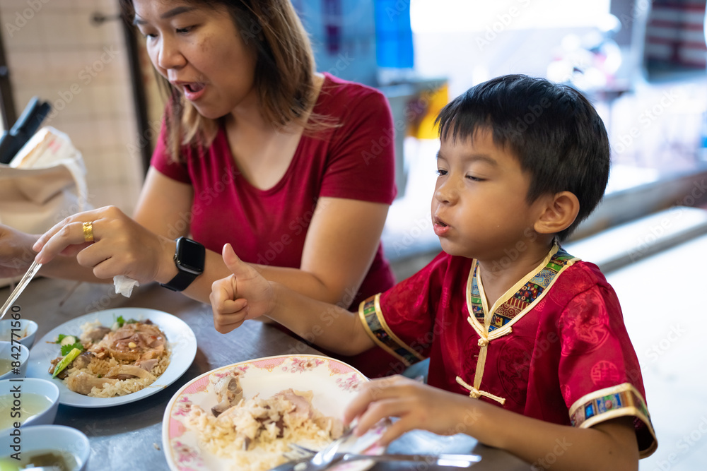Little asian boy with mom eat steam rice in street food local city Yaowarat Little asian boy with mom eat steam rice in street food local city Yaowarat