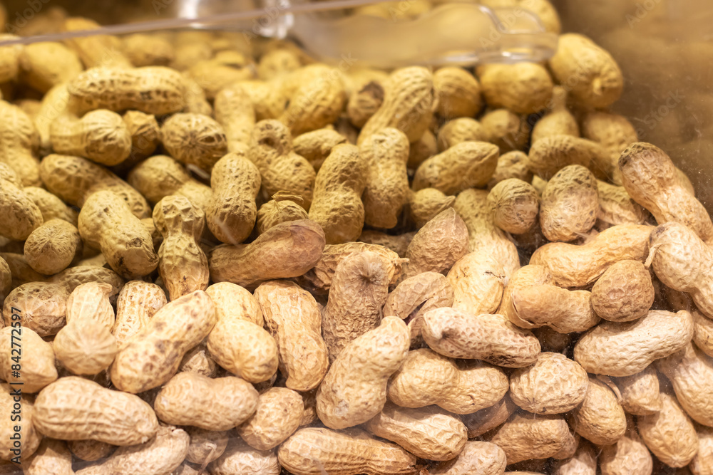 Peanuts are stored in a glass jar with their shells on