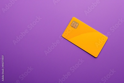 Vibrant yellow credit card on a purple background illustrating financial concepts photo