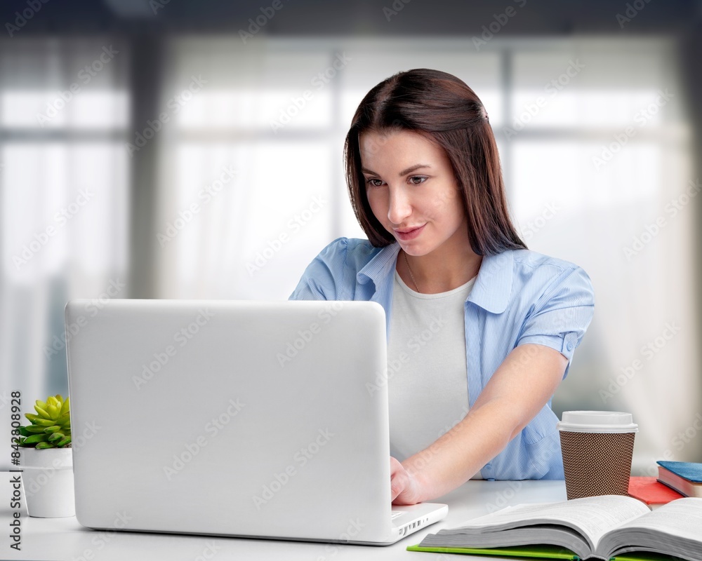 Woman sitting at work connecting with laptop Woman sitting at work connecting with laptop