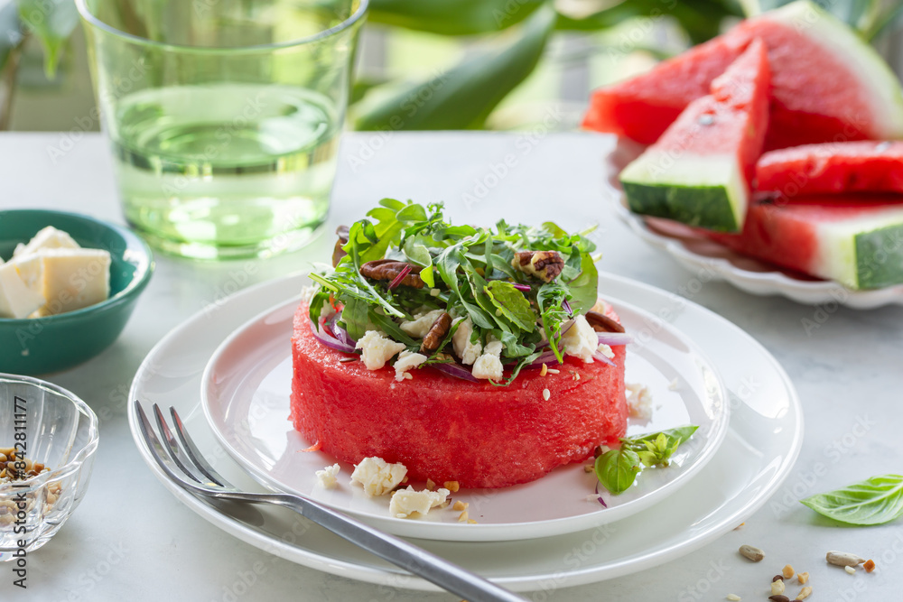 watermelon steak with feta cheese, greens and nuts, fresh raw summer meal watermelon steak with feta cheese, greens and nuts, fresh raw summer meal