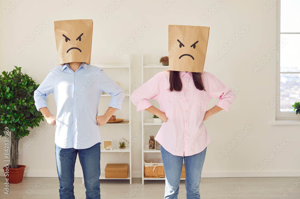 Faceless angry couple man and woman standing in the living room at home ...