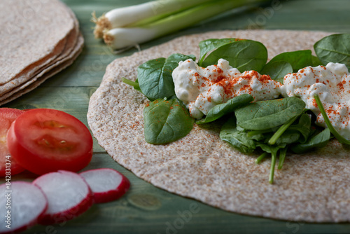 Whole meal wraps with cottage cheese,spinach and vegetables
 photo