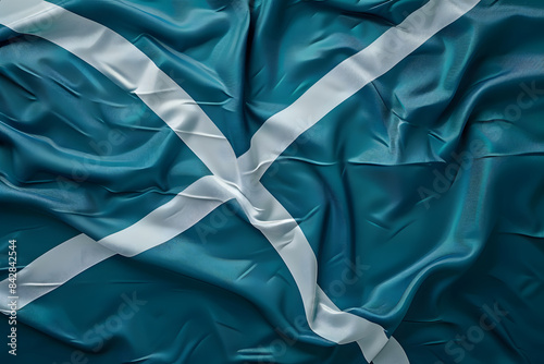 A detailed shot of the Scottish flag (Saltire) on a solid green background
