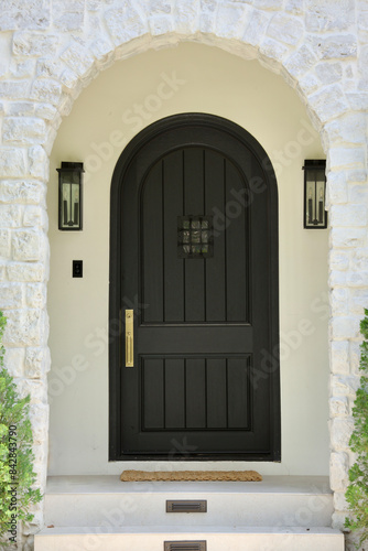 black arch front door on a white house