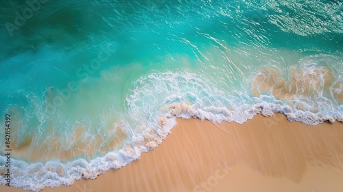 Aerial view of a beautiful sandy beach with turquoise ocean waves