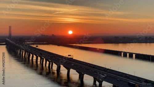 Sunrise over river at Horizon in orange sky - time lapse 