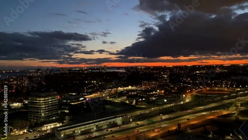 Sunset timelapse aerial view over highway traffic in a city