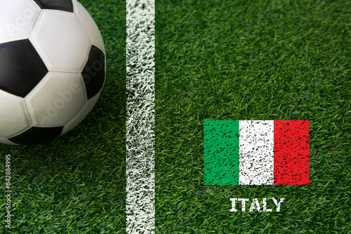 European football cup tournament 2024; soccer ball on green grass with national flag; Italy