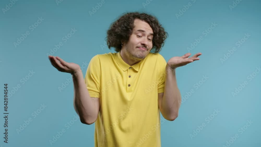 Confused curly haired man, shoulders up - can't help, makes gesture I dont know