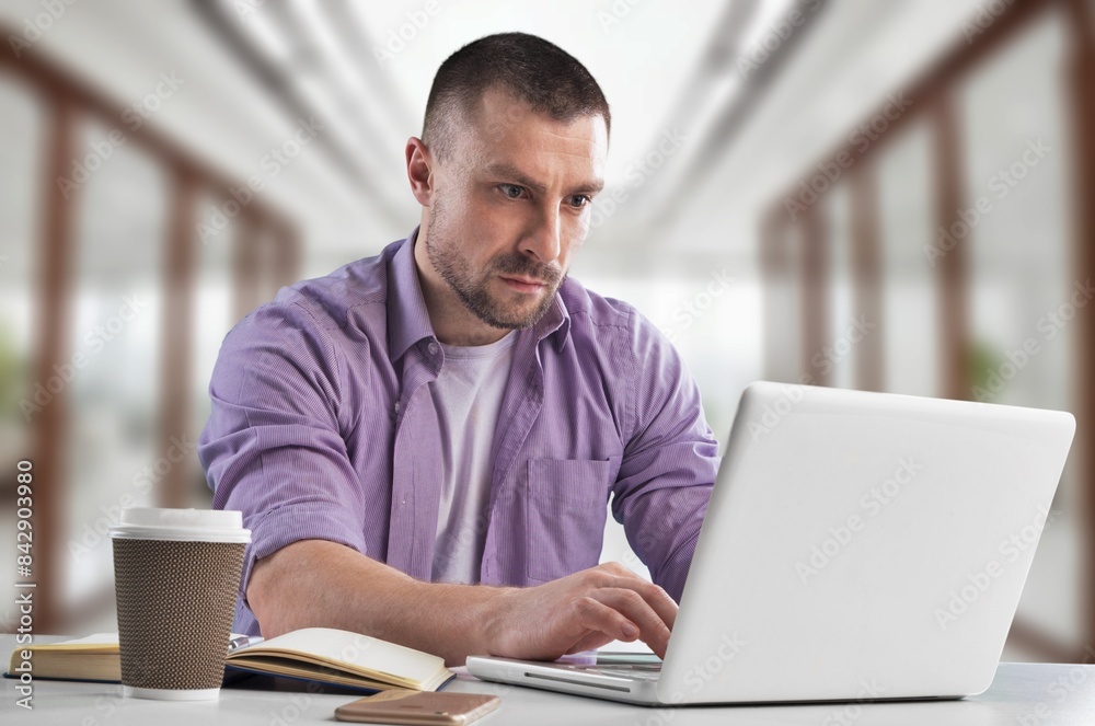 Smiling busy professional businessman work on laptop Smiling busy professional businessman work on laptop