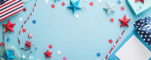 A flat lay of Independence Daythemed cards and decorations, on a clean, light blue background with ample copy space photo