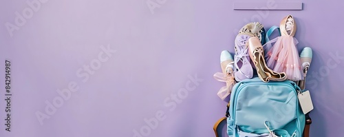 Dusty lavender background  ocean blue backpack brimming with ballet dance gear  including shoes and costumes  text space above  aerial view.