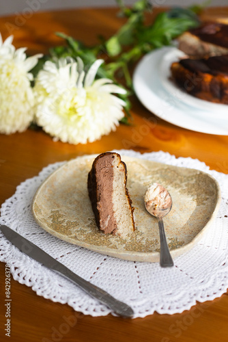 Homemade banana and chocolate Basque cheesecake with the cut piece on plate