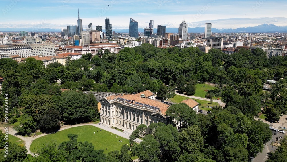 Italy, Milan , drone aerial view of Villa Reale and the new skyline with modern skyscrapers in downtown of the fashion city in Giardini di Porta Venezia Montanelli park . Milan Green city