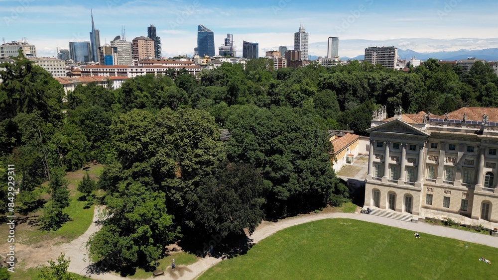 Italy, Milan , drone aerial view of Villa Reale and the new skyline with modern skyscrapers in downtown of the fashion city in Giardini di Porta Venezia Montanelli park . Milan Green city