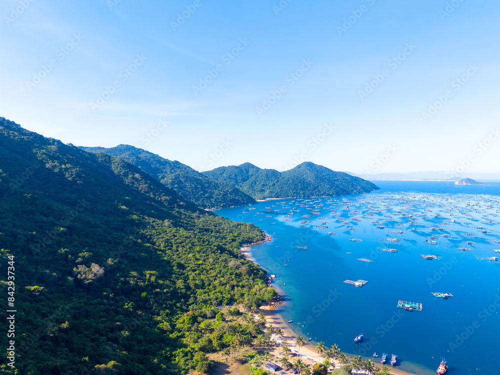 Aerial view of the lobster feeding farms, float fishing village in Vung Ro bay, Phu Yen, Vietnam. This is a very popular tourist destination. Aerial view of the lobster feeding farms, float fishing village in Vung Ro bay, Phu Yen, Vietnam. This is a very popular tourist destination.