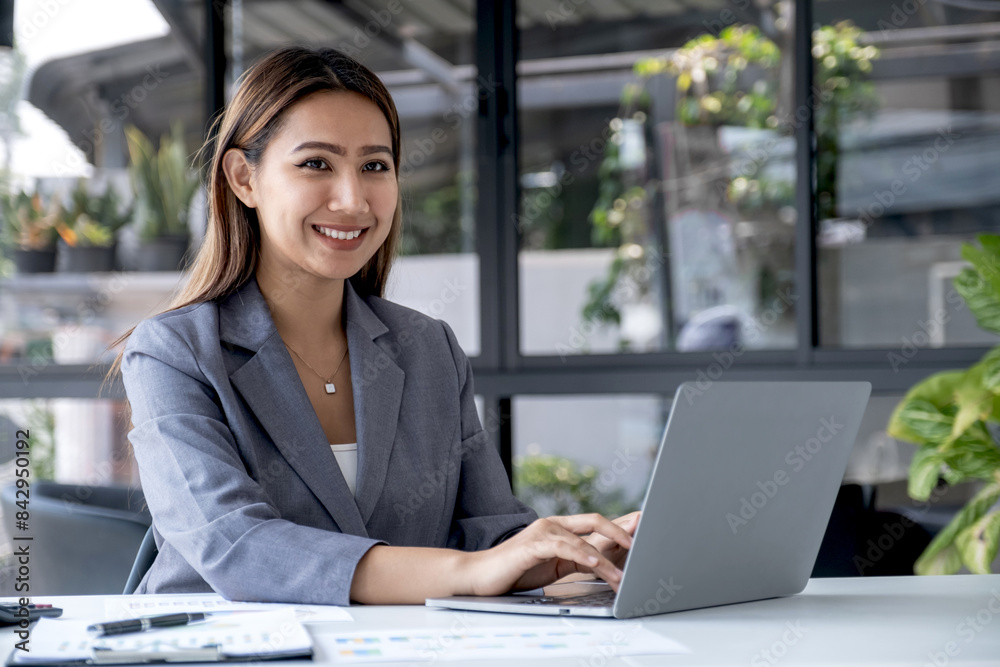 Businesswomen bookkeeper use laptop analysis the graph for Setting challenging business goals and ready to achieve target at home office Businesswomen bookkeeper use laptop analysis the graph for Setting challenging business goals and ready to achieve target at home office