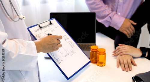 The doctor explained the health examination results and the medical checkup concept to a couple of patients