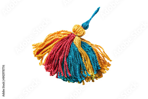 Close-up of a colorful handmade yarn tassel with red, blue, and yellow threads. Perfect for crafts, decorations, or accessory designs. photo